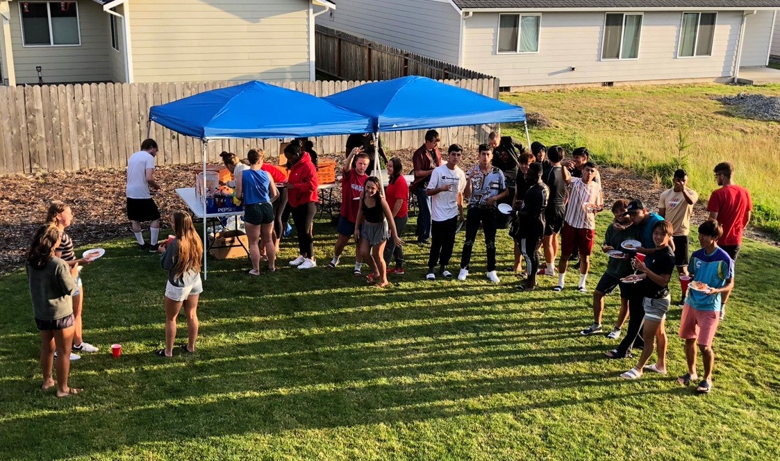 Open house attendees enjoying a barbecue on the CHI lawn.