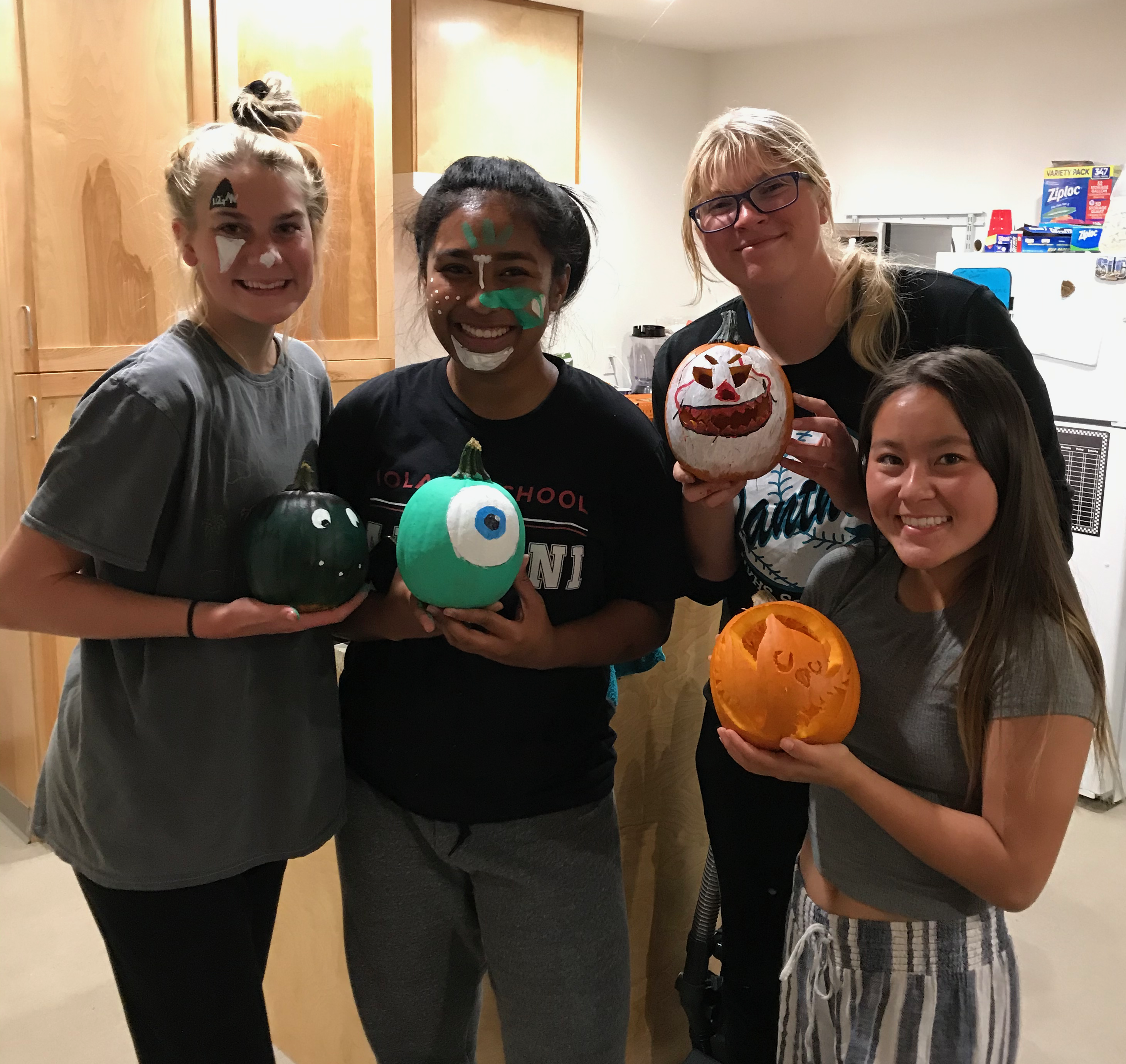 Four residents and four decorated pumpkins